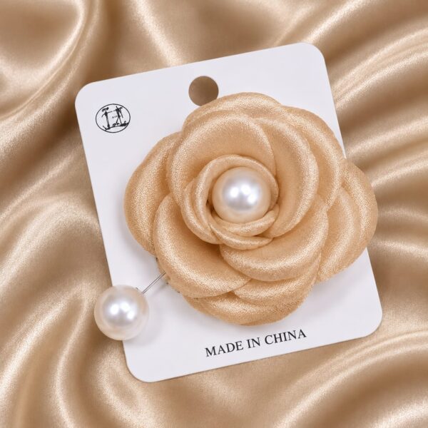 Amber colored brooch with pearl can be used for hijabs and for sarees