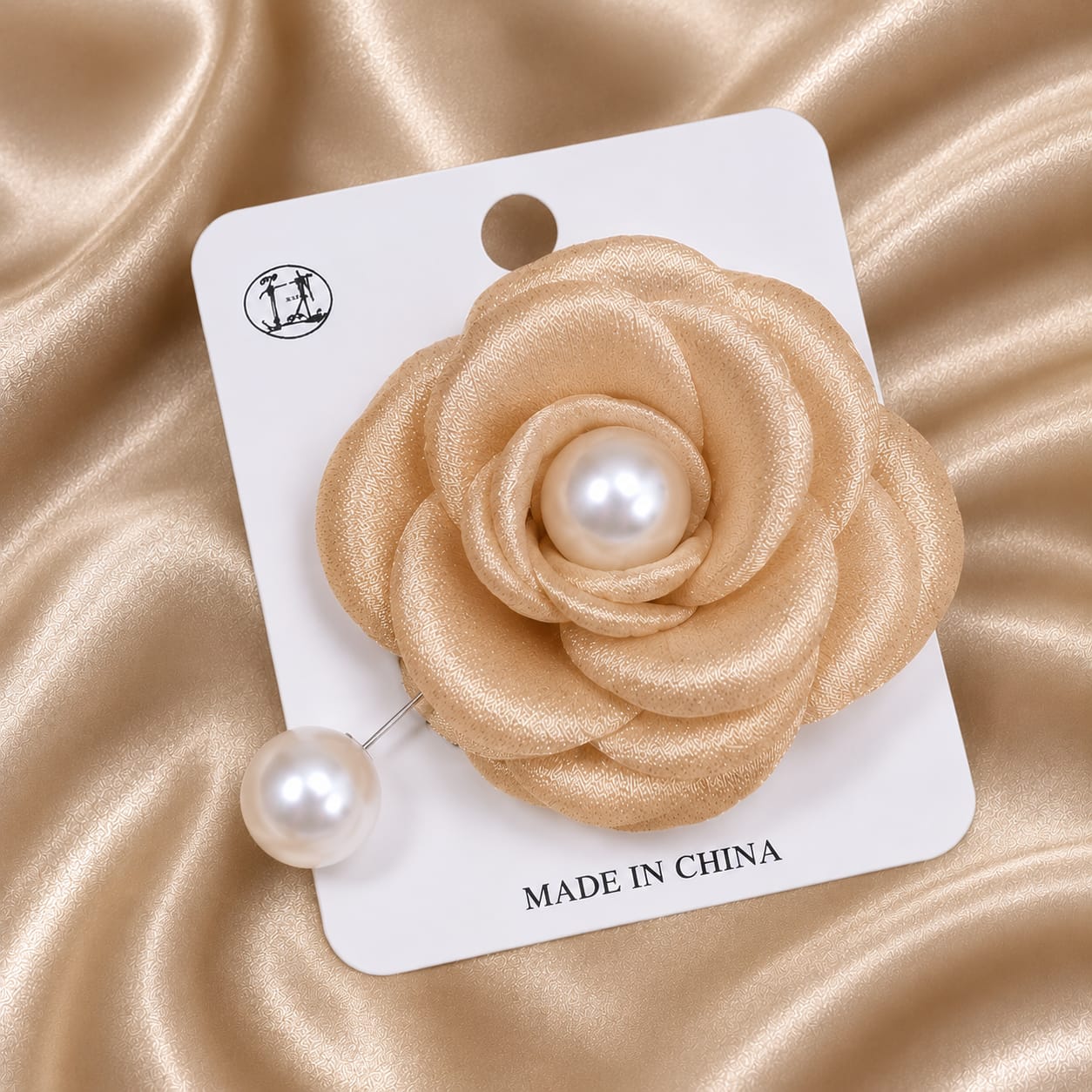 Amber colored brooch with pearl can be used for hijabs and for sarees
